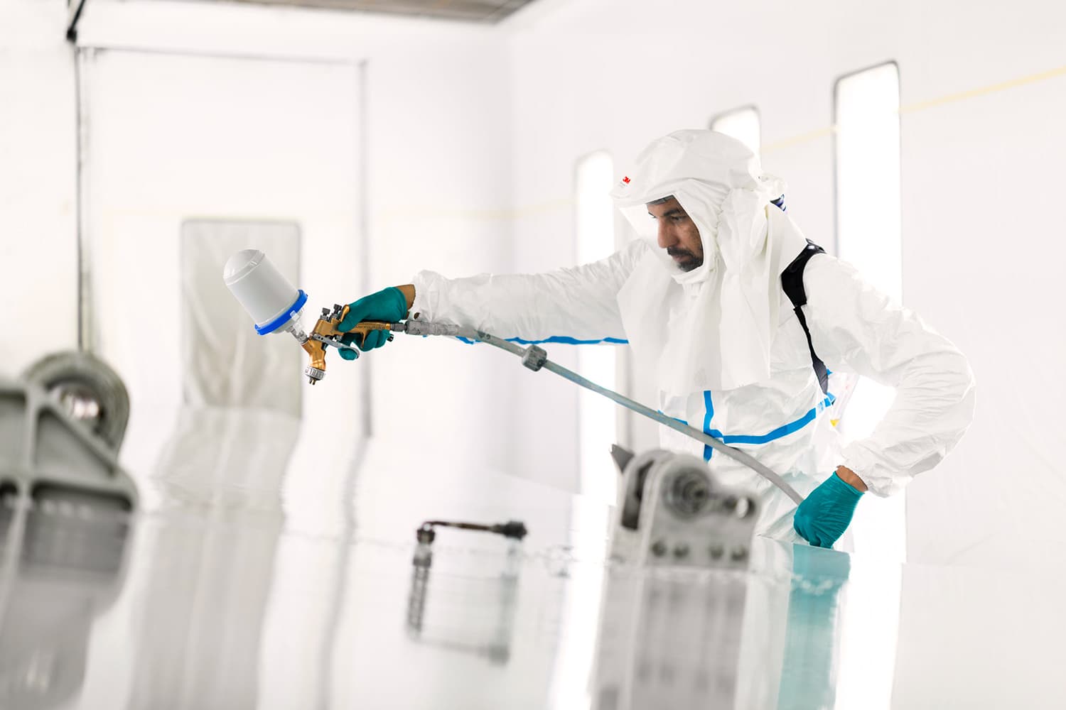 Sabena technics technician painting an aircraft in a specialized and dynamic work environment