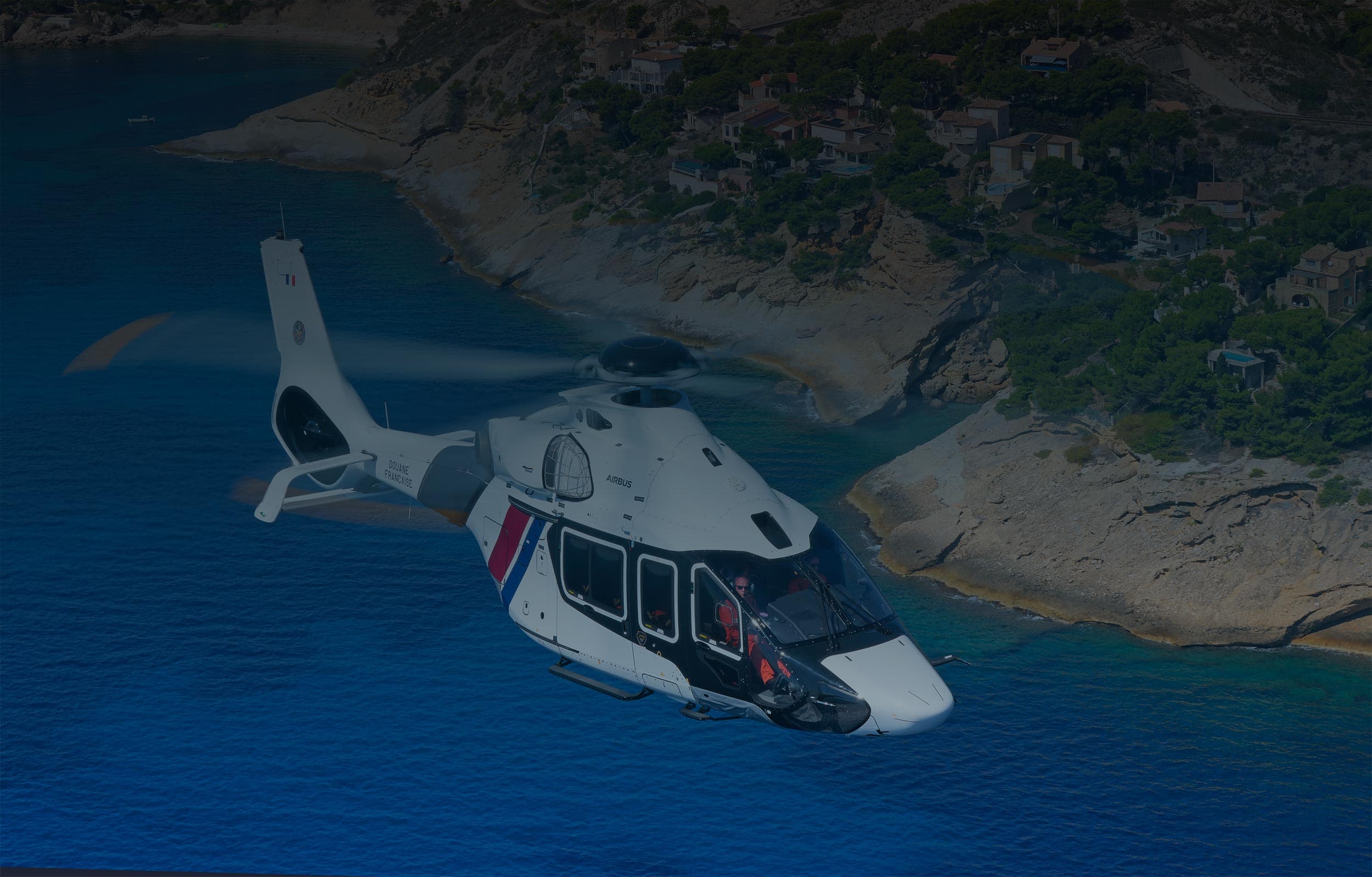 H160 helicopter flying over the coastline, used by the Police for surveillance, search and rescue missions as part of a Sabena technics project